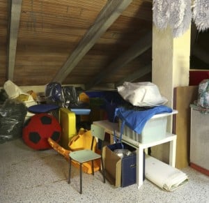 Attic with many things throw and clothes hung out to dry