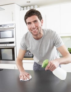 Man cleaning kitchen counter