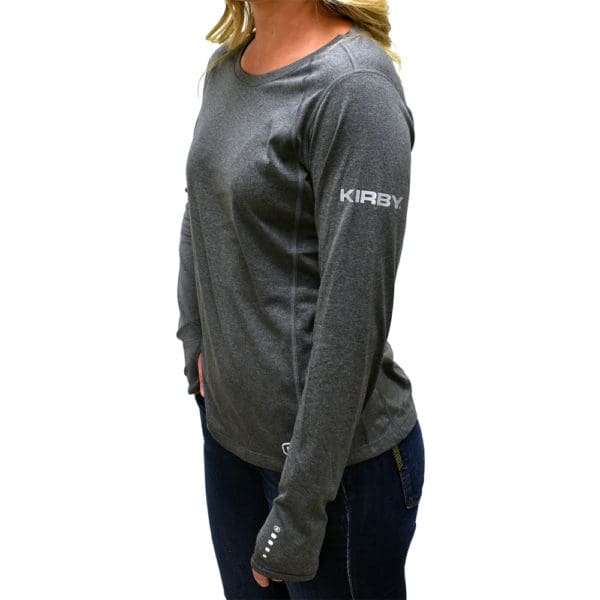 Woman wearing a gray Kirby long-sleeve athletic shirt.