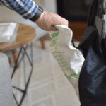 "Man easily installing Kirby HEPA filter bag into vacuum cleaner."