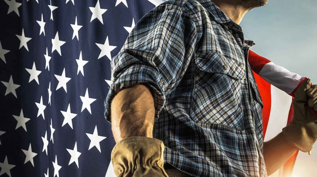 Patriotic man holding American flag with leather gloves.